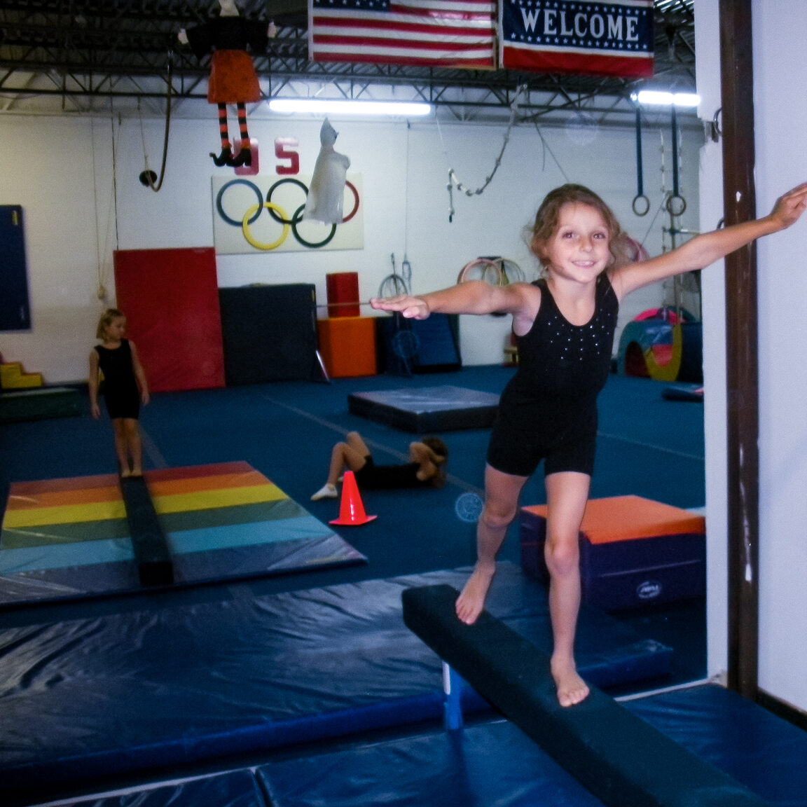 young girl on balancing beam